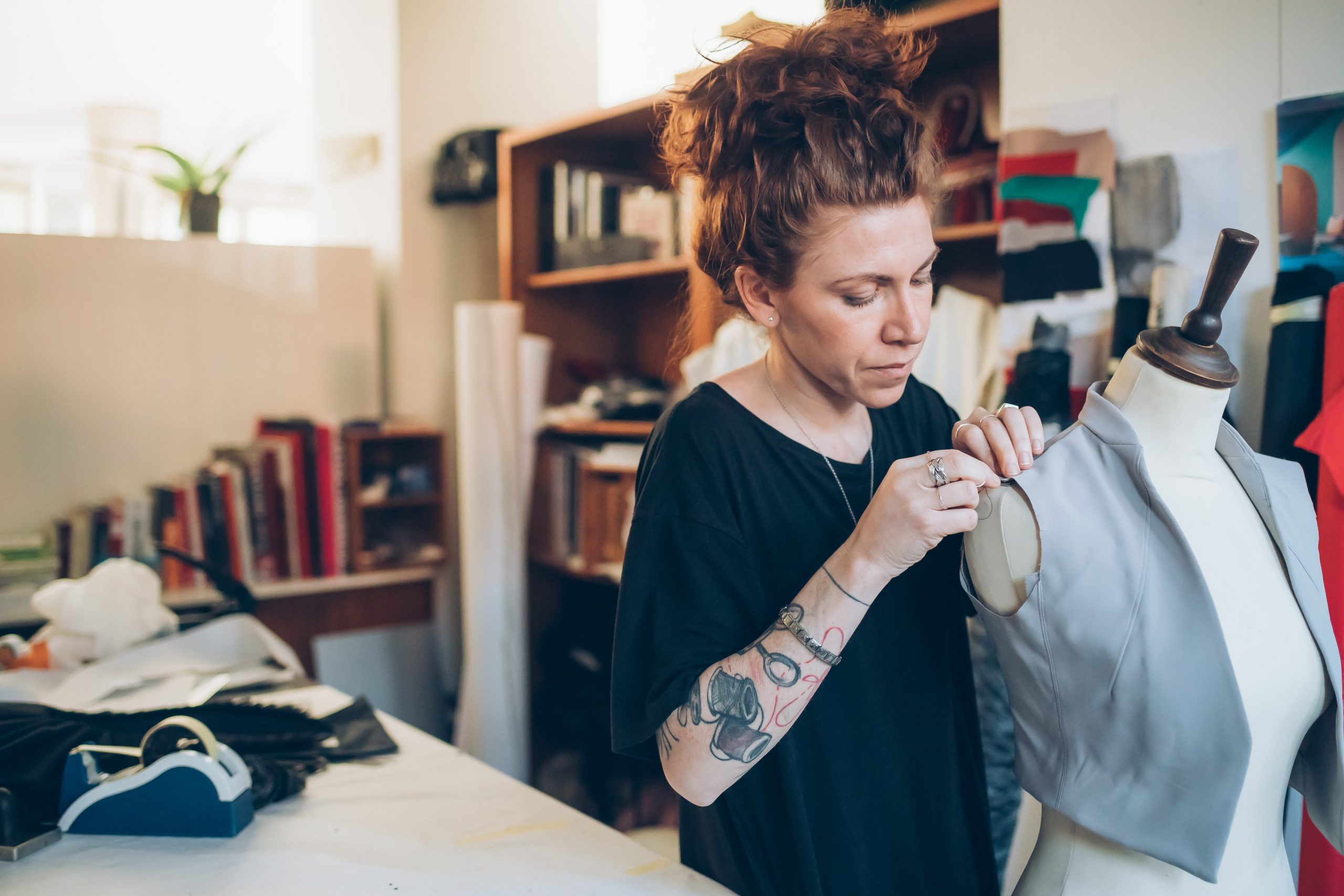 Female working on waistcoat on tailor's dummy